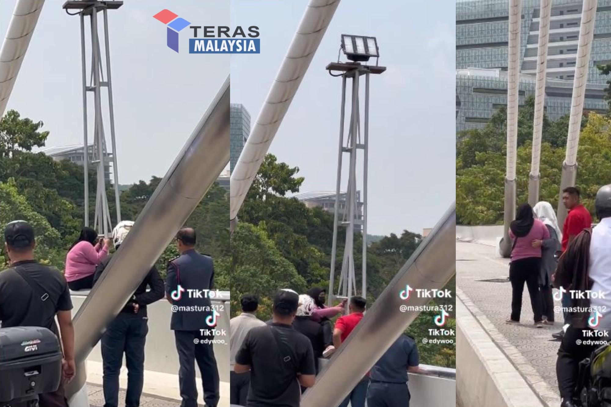 Orang kecut perut tengok wanita duduk atas jambatan Putrajaya ini cara macam nak bunuh diri